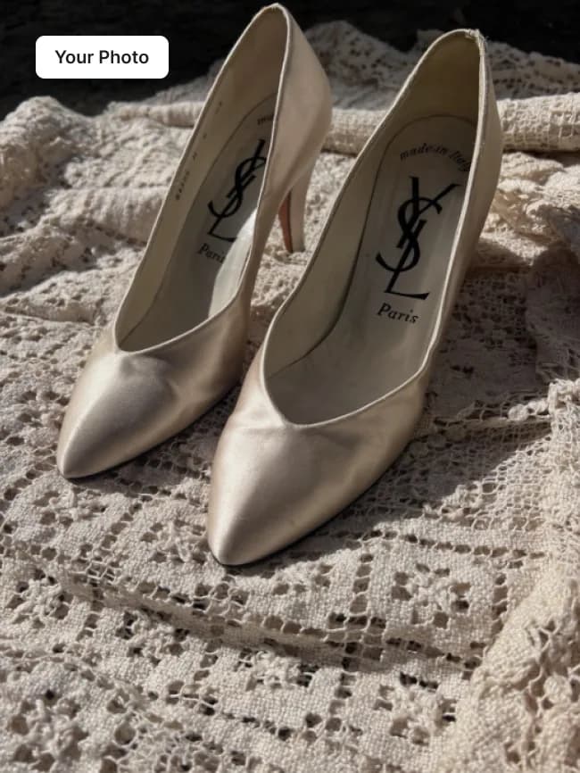 Plain phone photo of champagne pointed-toe heels on a lace cloth