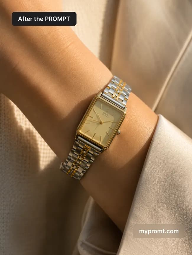 Gold and steel watch worn on a wrist beside an ivory blazer sleeve in warm morning light